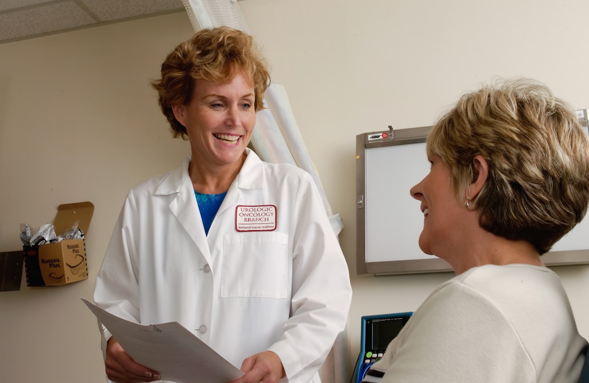 A physician warmly talking with a patient — clear messaging that earns trust at a Direct Primary Care practice